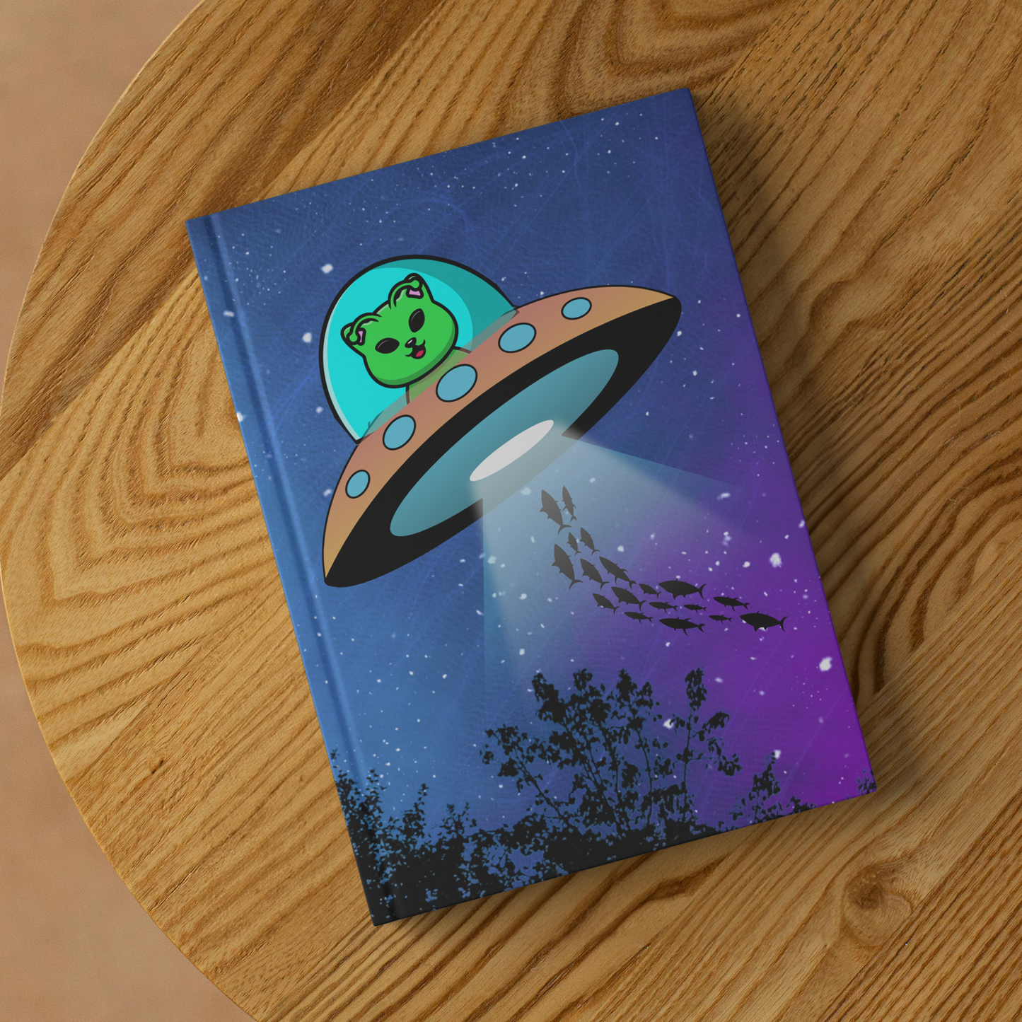 Alien_Cat_Beaming_up_Fish_Hardcover_Jour_Lifestyle_2_Mockup.png